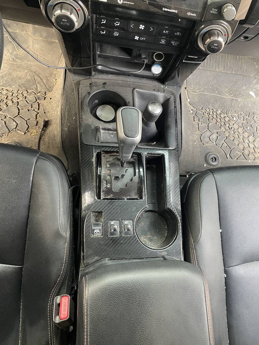 Toyota 4Runner TRD Pro center console before detailing — dust and grime around the shifter and cup holders