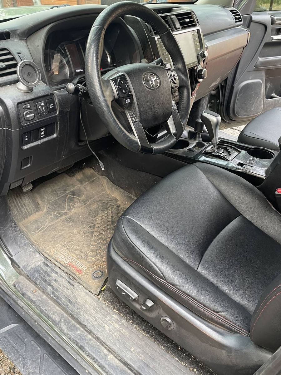 Toyota 4Runner TRD Pro driver's side before detailing — mud tracked over the sill and kick panel