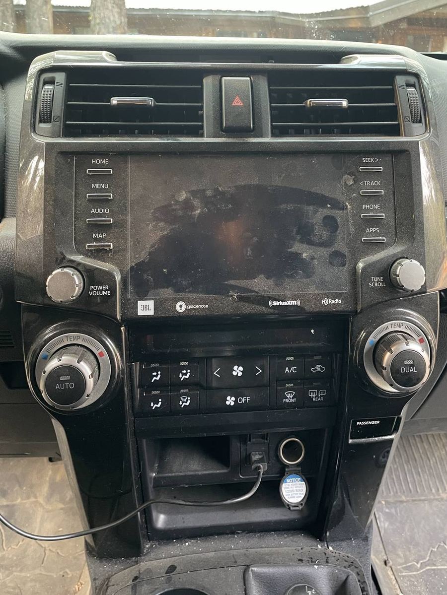 Toyota 4Runner TRD Pro infotainment before detailing — dust and fingerprints across the screen