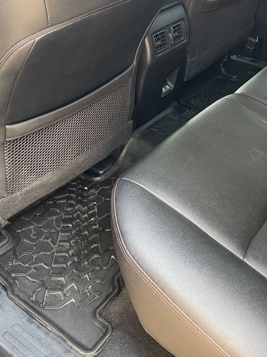 Toyota 4Runner TRD Pro rear footwells after detailing — mats scrubbed clean and the carpet edges clear