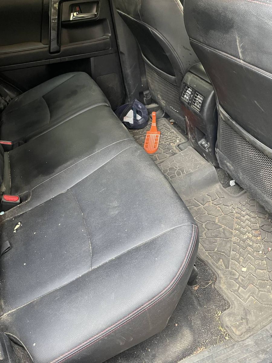 Toyota 4Runner TRD Pro rear seats before detailing — dust across the seat backs and debris in the footwell
