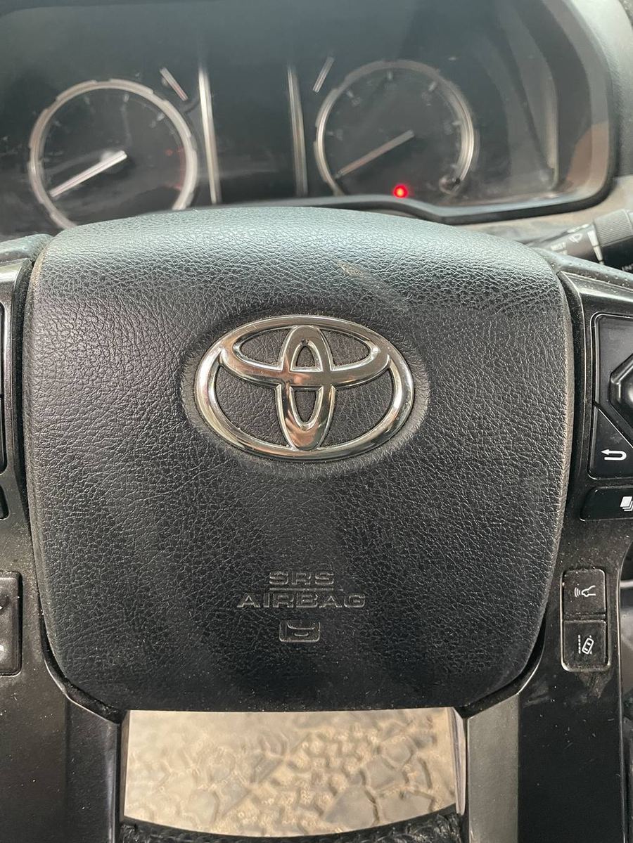 Toyota 4Runner TRD Pro steering wheel before detailing — dust settled into the wheel grain and badge