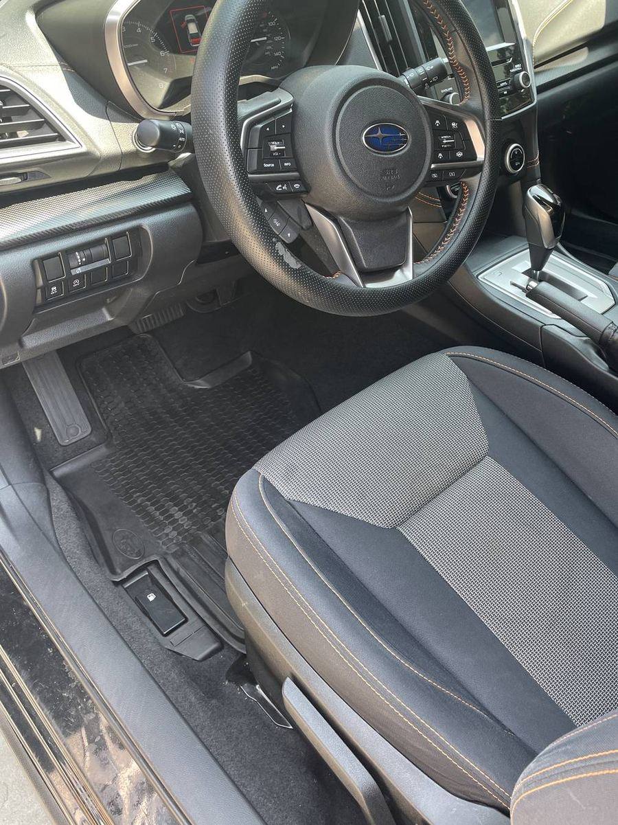 Subaru Crosstrek driver's side after detailing — sill, seat base and carpet edge cleaned