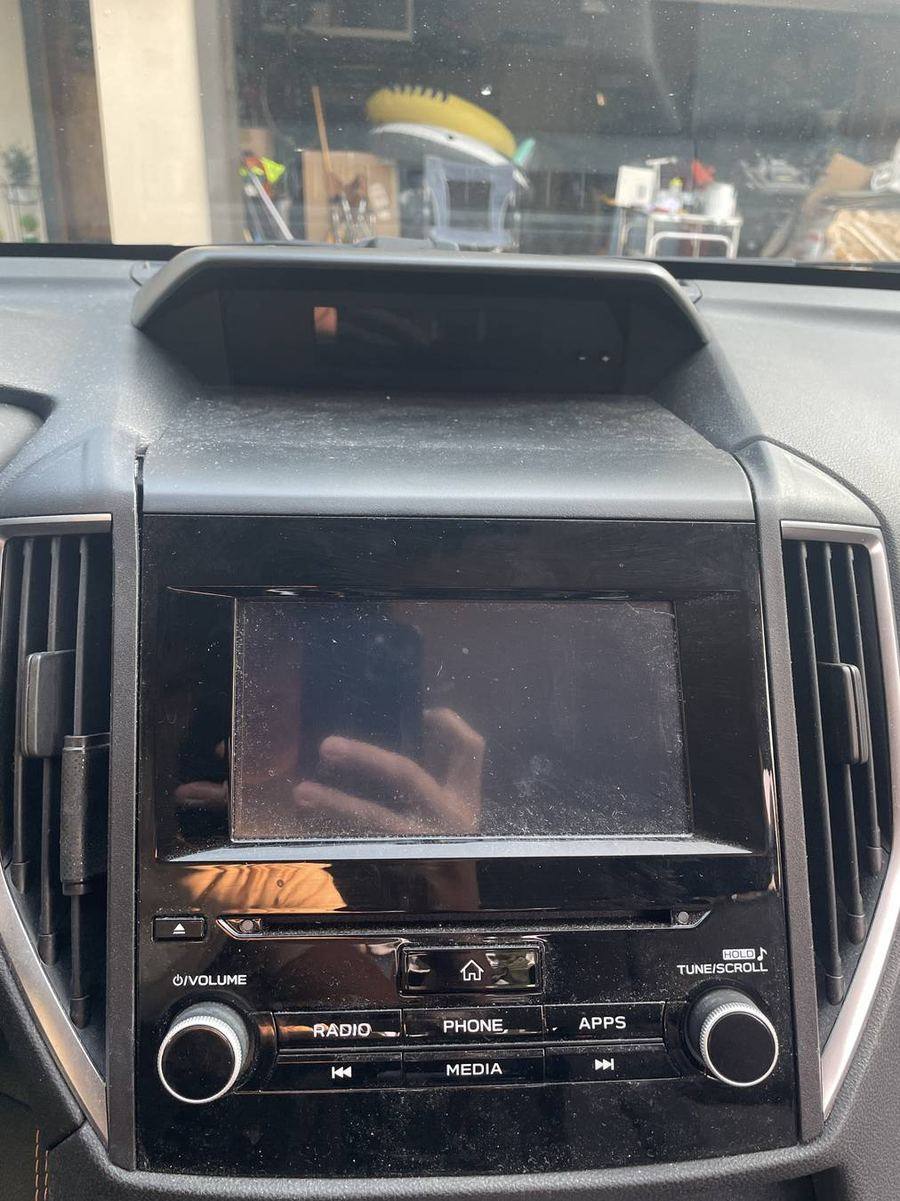 Subaru Crosstrek infotainment before detailing — dust and fingerprints across the glass