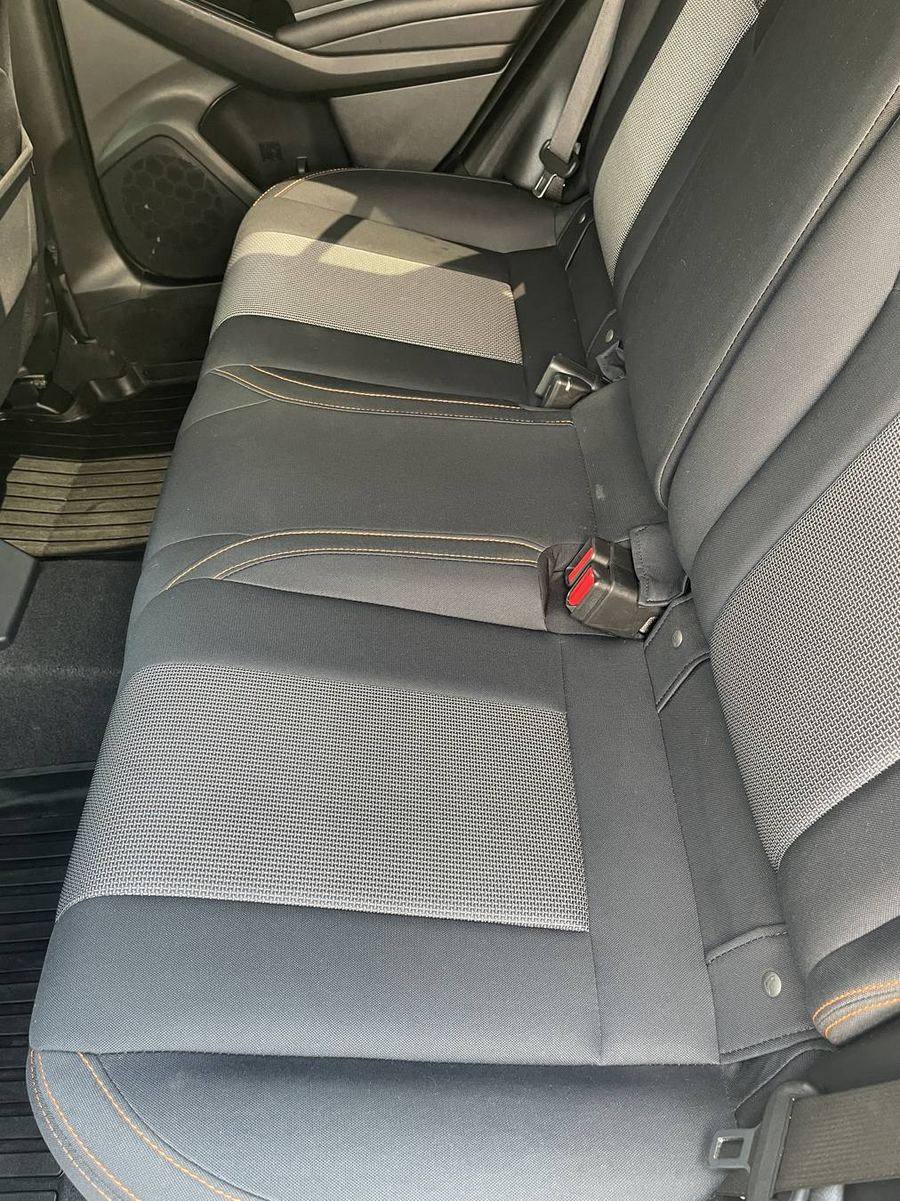 Subaru Crosstrek rear bench after detailing — two-tone fabric weave reading clean and even