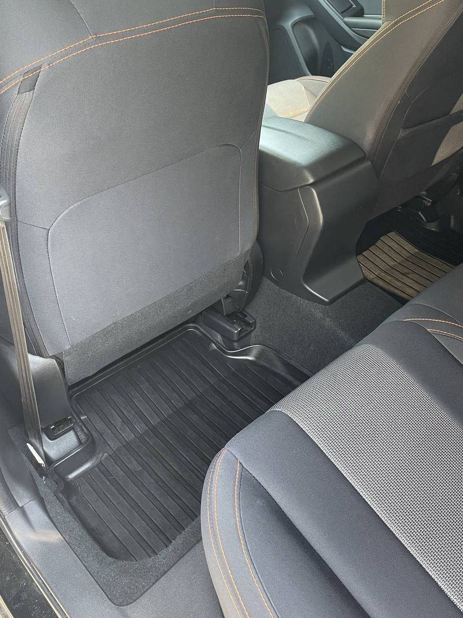 Subaru Crosstrek rear footwells after detailing — mats and carpet edges an even, clean black