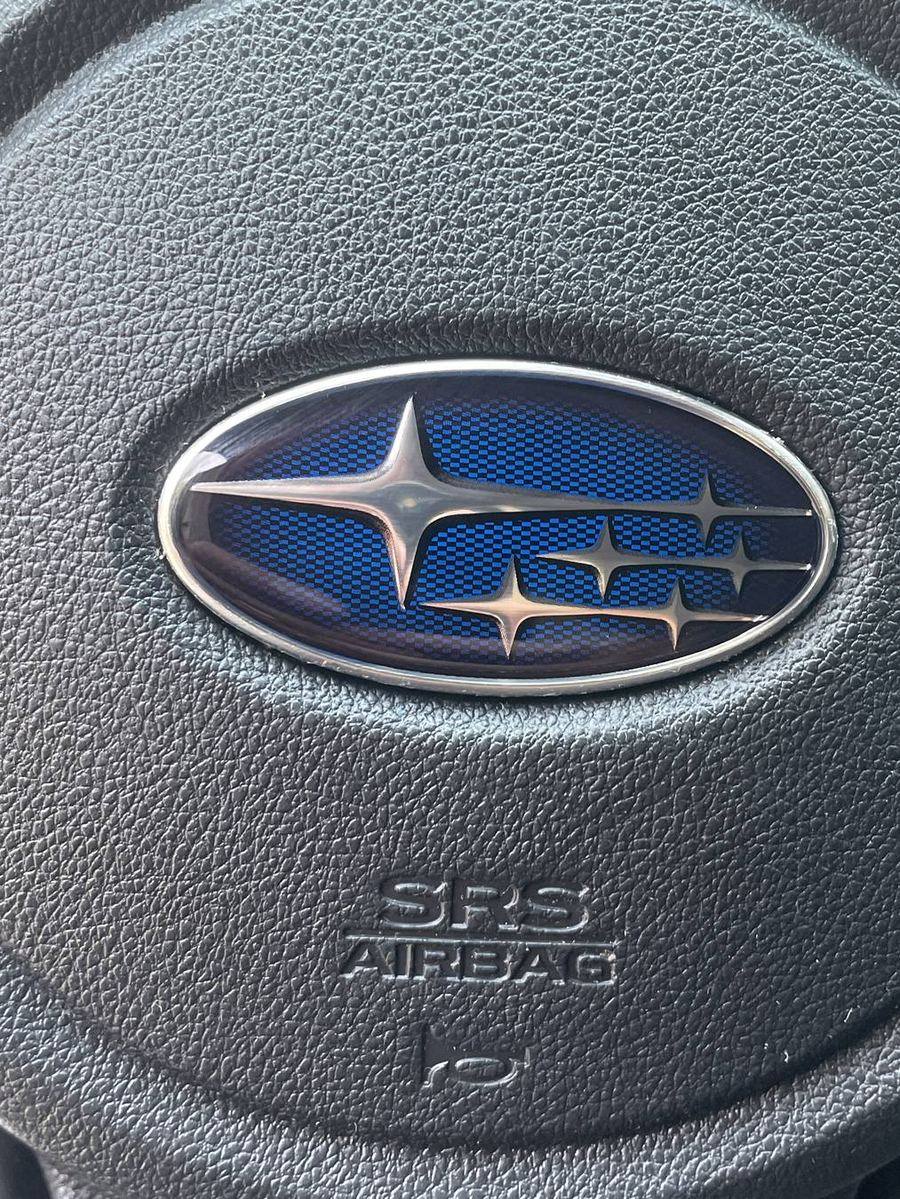 Subaru Crosstrek steering wheel after detailing — badge and textured trim clean